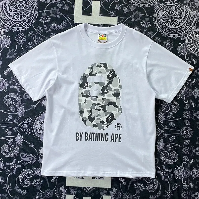BAPE White T - Shirt with Camouflage Ape Head & "BY BATHING APE" Text